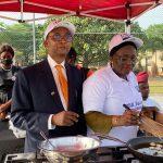 US Mission Counselor for Agricultural Affairs Gerald Smith with a chef making bean cake from Bt Cowpea at the event on Thursday