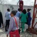 Naira Scarcity: Bankers In Viral Video Flee Angry Customers Through Back Fence