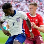 Saka holds off Michel Aebischer in the match against Switzerland
