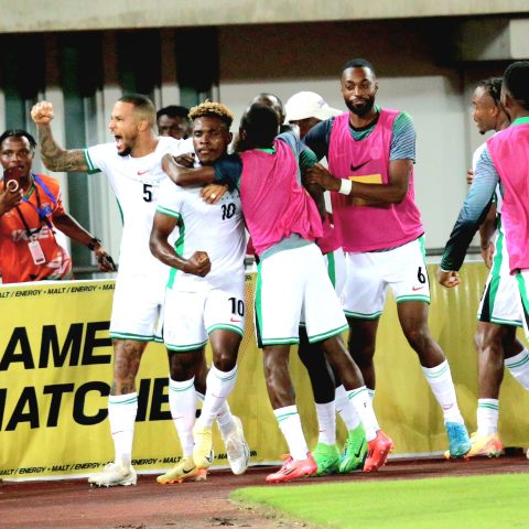 Teammates mob Dele Bashiru after his saved the day with a lone goal