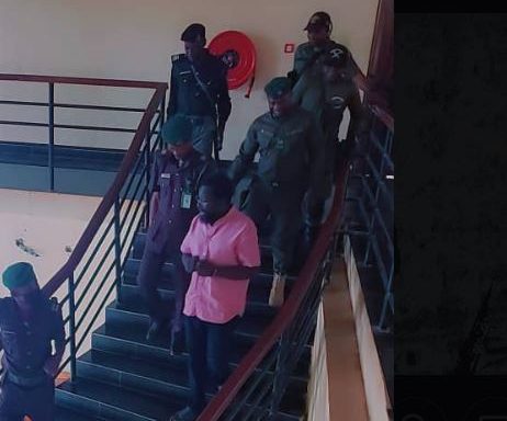 Dele Farotimi in handcuffs (pink shirt) at court today