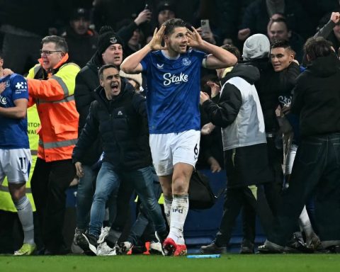 Everton captain James Tarkowski is mobbed by fans as he celebrates scoring the equaliser against Liverpool