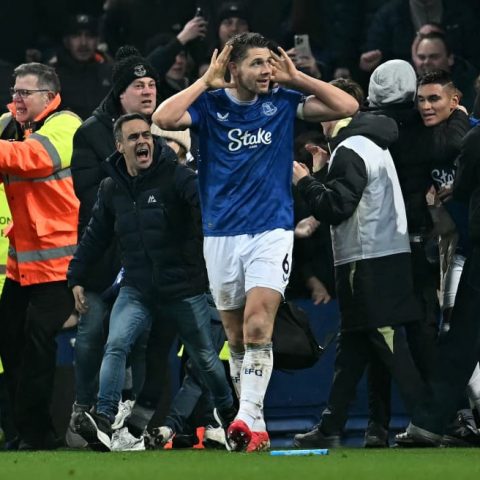 Everton captain James Tarkowski is mobbed by fans as he celebrates scoring the equaliser against Liverpool