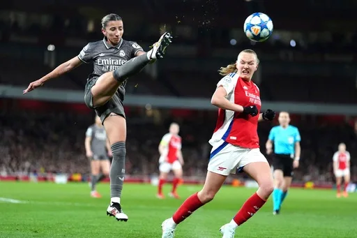 Real Madrid's Sheila Garcia left and Arsenal's Frida Maanum battle for the ball during the Women's Champions League quarter final Wednesday