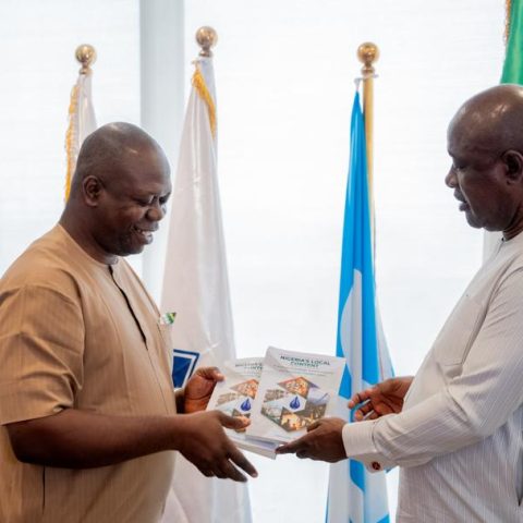 Ezeobi presents copies of his book to Minister Lokpobiri