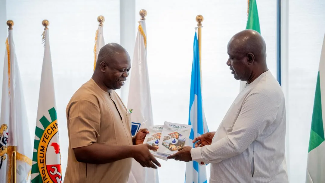 Ezeobi presents copies of his book to Minister Lokpobiri
