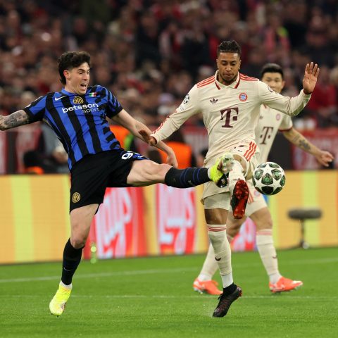 Michael Olise of Bayern Munich is challenged by Alessandro Bastoni of FC Internazionale