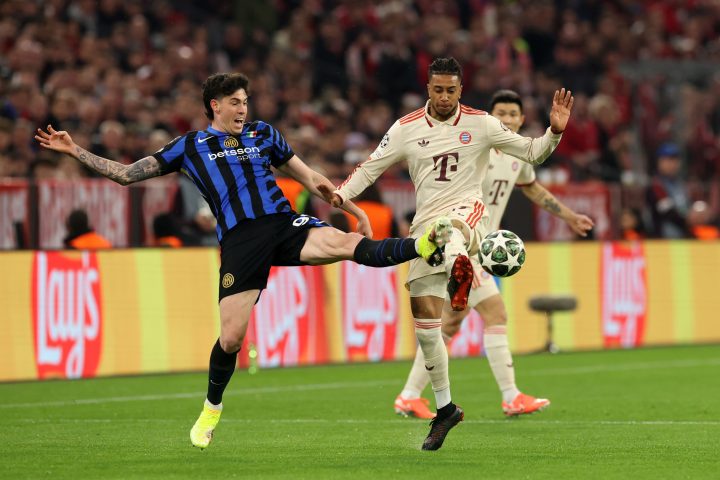Michael Olise of Bayern Munich is challenged by Alessandro Bastoni of FC Internazionale