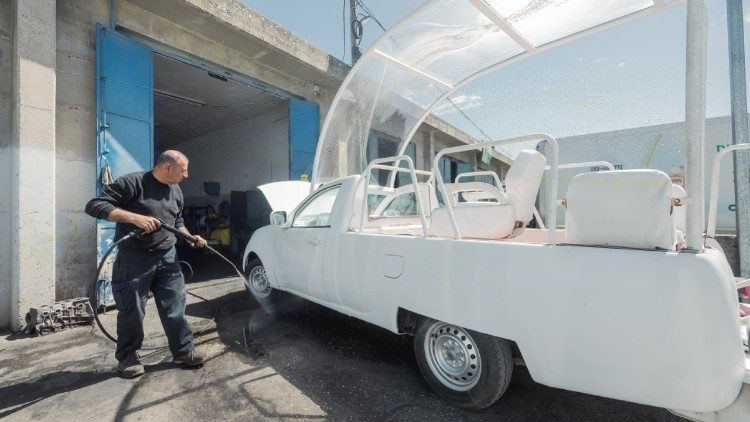 Men work on turning the popemobile into a health clinic (Caritas )