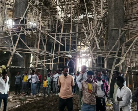 Worshippers stand inside the Menjar Shenkora Arerti Mariam Church under construction that collapsed in Arerti, Amhara region of northern Ethiopia, on Wednesday, October 1, 2025 [Samuel Getachew/AP Photo]