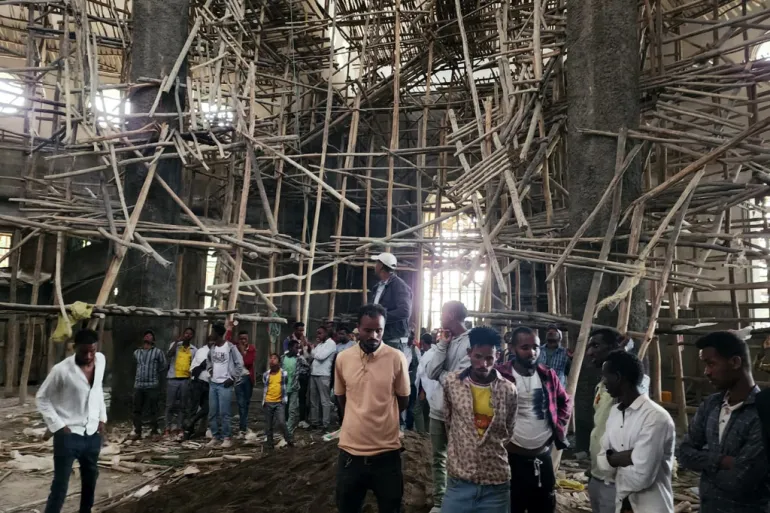 Worshippers stand inside the Menjar Shenkora Arerti Mariam Church under construction that collapsed in Arerti, Amhara region of northern Ethiopia, on Wednesday, October 1, 2025 [Samuel Getachew/AP Photo]
