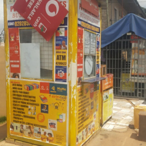 Image of Ghana Mobile Money Kiosk and Ghana Flag